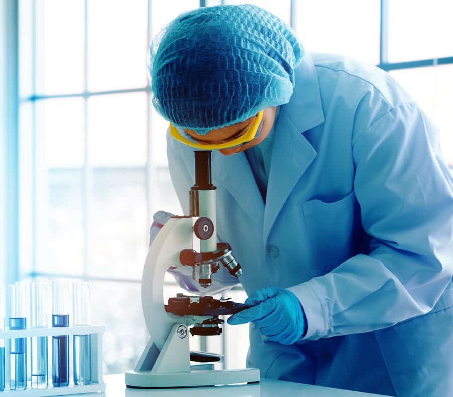 doctor looking into microscope