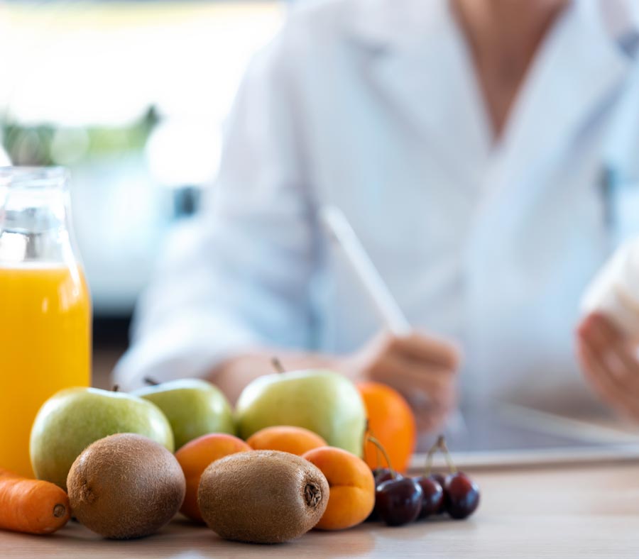 nutritionist with fresh fruit on table